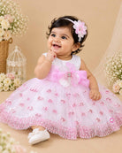 Sleeveless net fit-and-flare girl frock with floral waist appliqué and sequin detailing for parties.