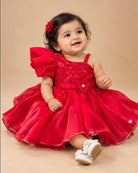 Girls sequin one shoulder frock with dramatic ruffle sleeve, floral waist applique, and flared layered skirt.