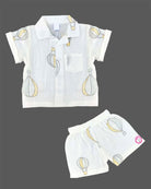 Boys 2-piece cotton casual co-ord set featuring a short-sleeve collared printed shirt and matching shorts in white with pastel yellow and grey hot air balloon prints