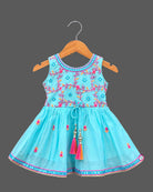 Girls sleeveless embroidered peplum kurti paired with tiered flared sharara pants featuring tassel ties.
