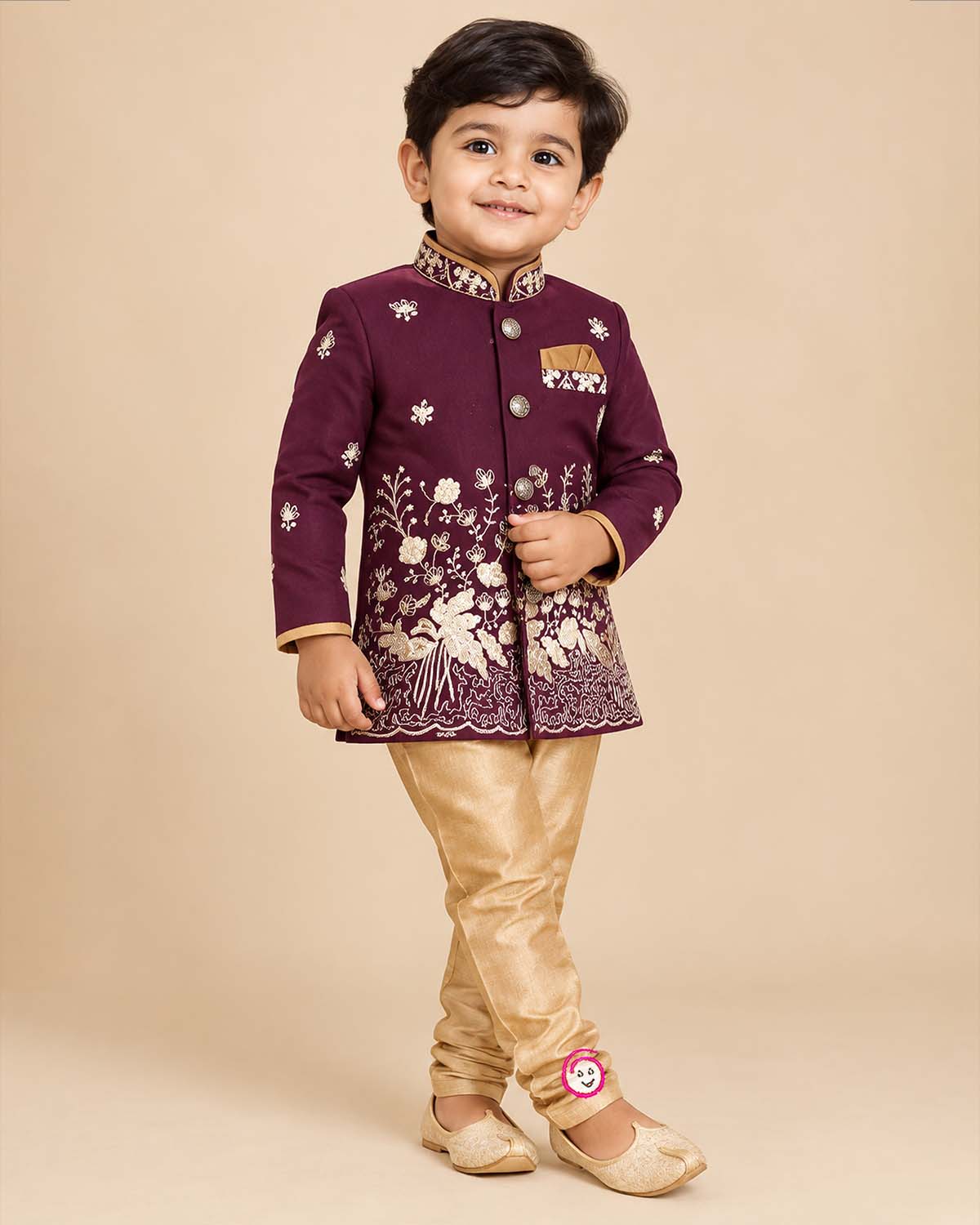 Little boy wearing purple and gold embroidered silk sherwani suit for weddings and festive functions