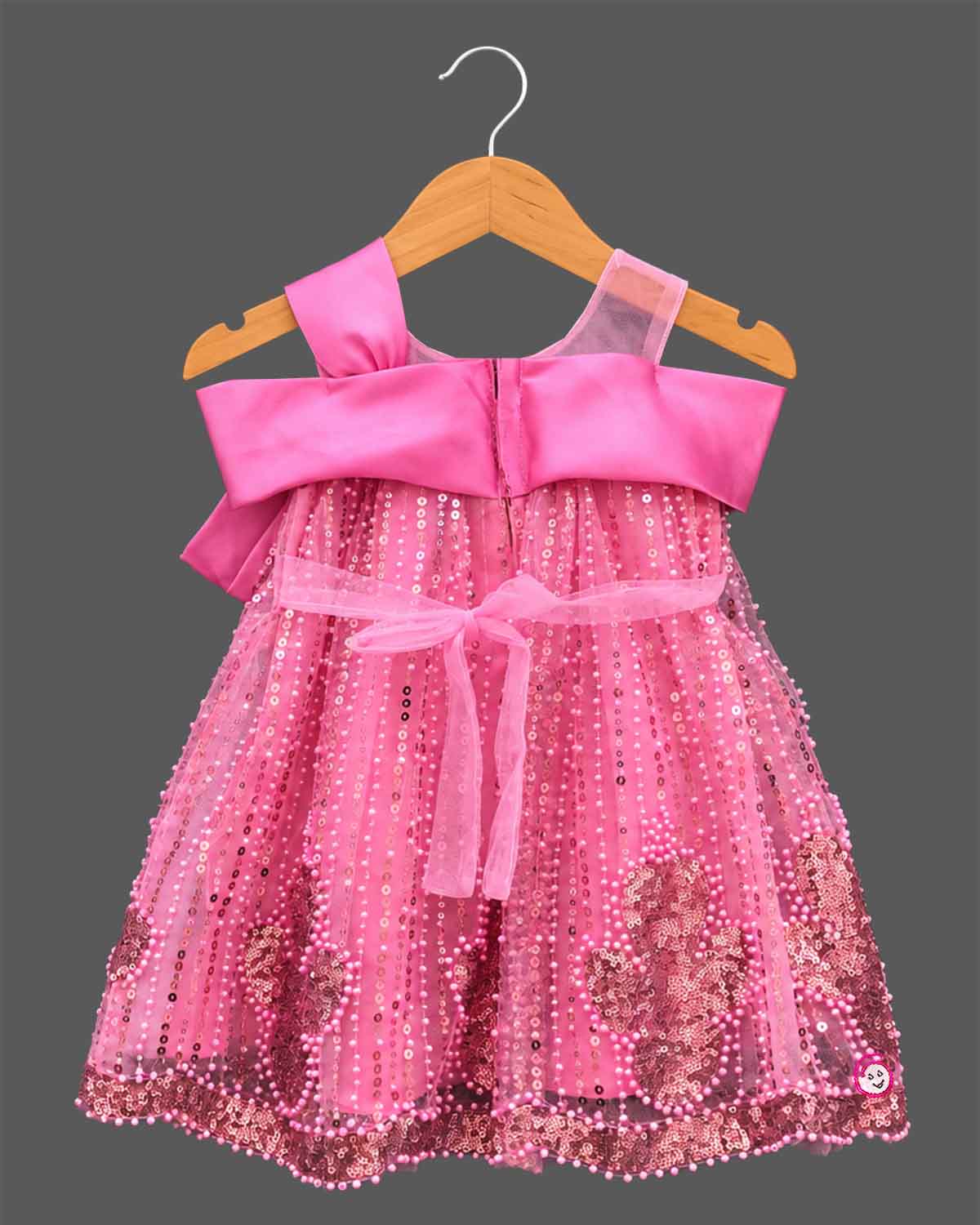 Girls sequin embellished A-line frock with large front satin bow, illusion mesh straps, and pearl beaded trim.