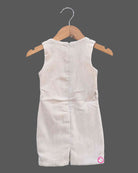 Black and white geometric jacket over a cream baby girl cotton midi dress for family dinners, evening outings, and smart casual wear