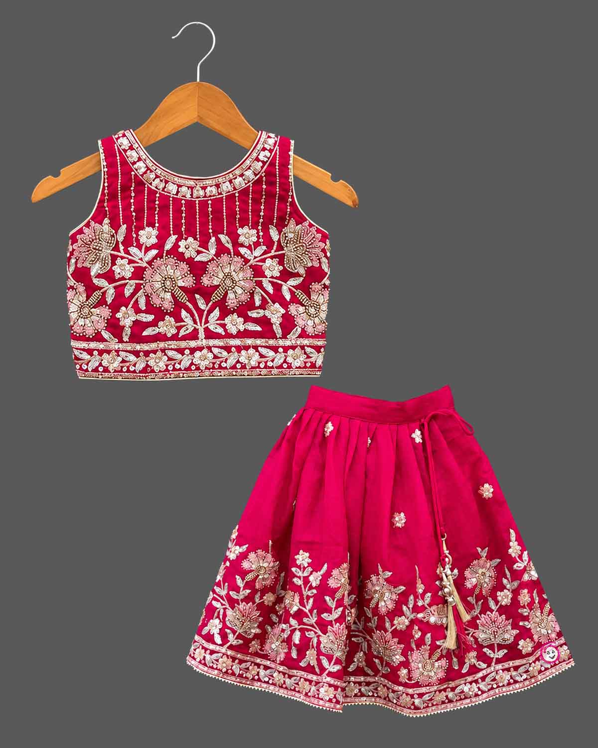 Lehenga choli for kids with beaded floral yoke, sleeveless round neck choli and pleated skirt with tassel tie