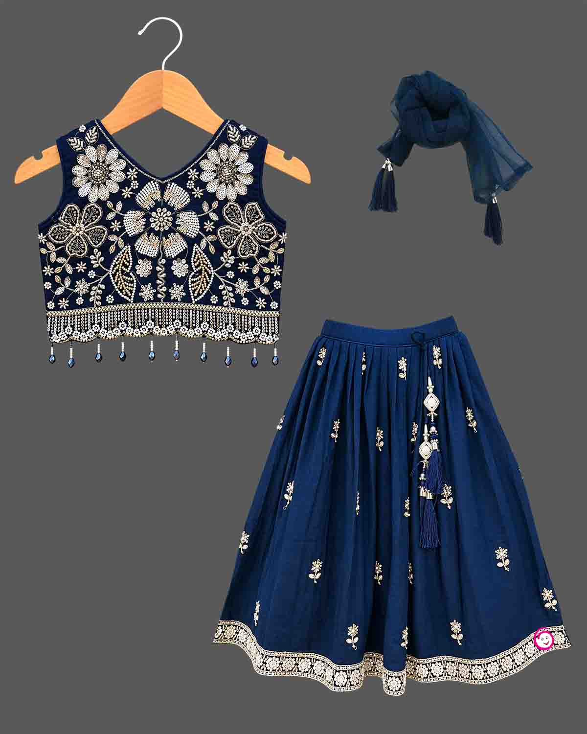 Girls sleeveless embroidered choli lehenga set with beaded fringe hem, tassel drawstring, and pleated flared skirt.