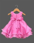 Sleeveless satin tiered party frock featuring three beaded rosettes at the waist and scalloped layered hem