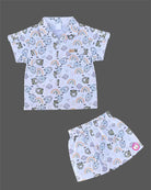 Boys 2-piece cotton casual co-ord set featuring a short-sleeve collared shirt and matching shorts in white with cute teddy bear faces, rainbows, and planet prints