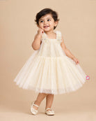 Cream Little Girl Tulle Party Frock with Polka Dots, Flower Details, and Square Neck on Hanger.