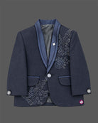 Navy blue formal tuxedo suit set for boys with crystal embellishments, shawl collar jacket, white shirt, tie, and pant for wedding party