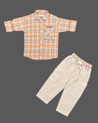 Toddler wearing checkered button-down shirt and pant designed as western dress for boys.