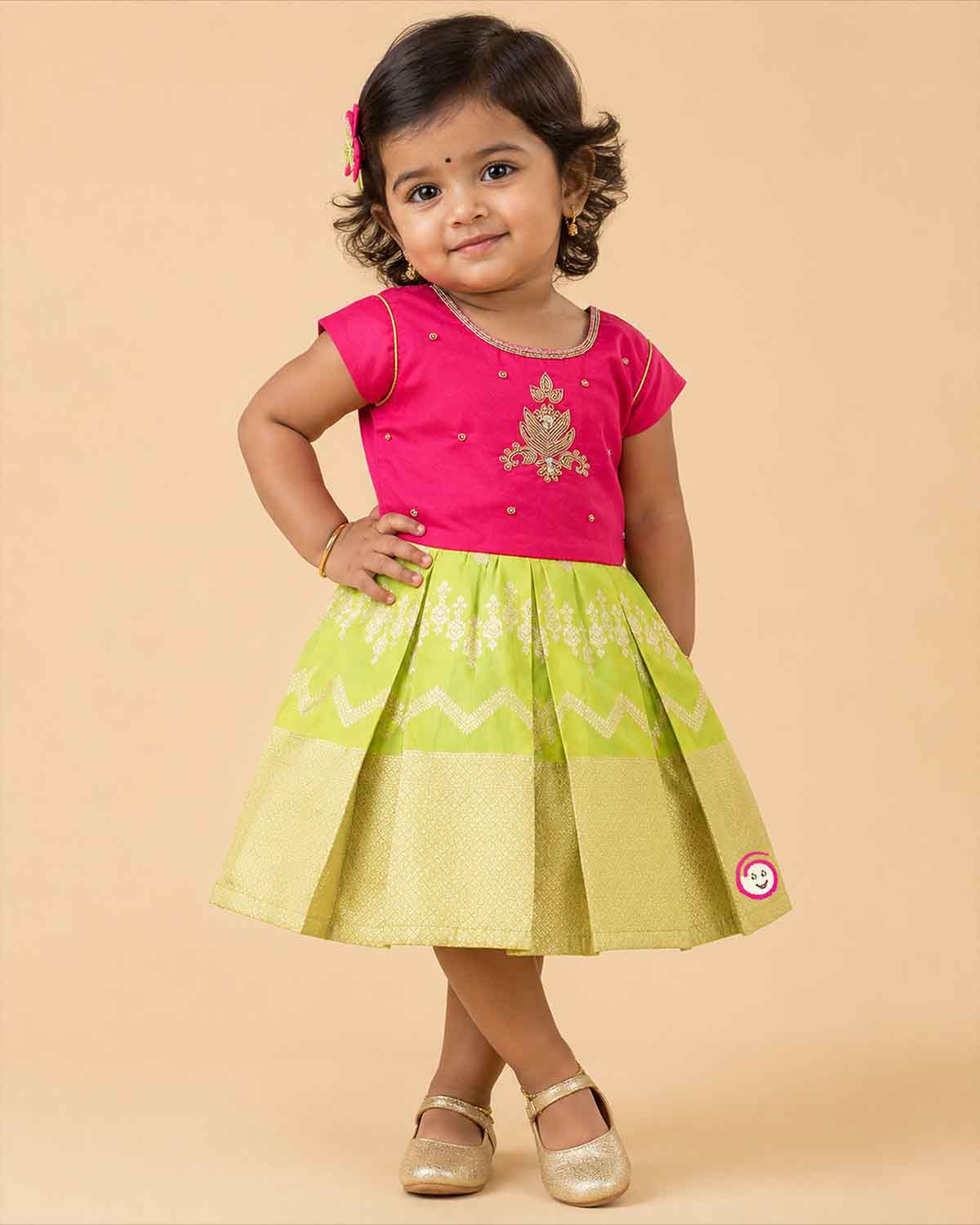 Infant cotton silk frock in magenta and lime green with traditional gold zari border and center motif embroidery for temple visits, festivals, and family functions