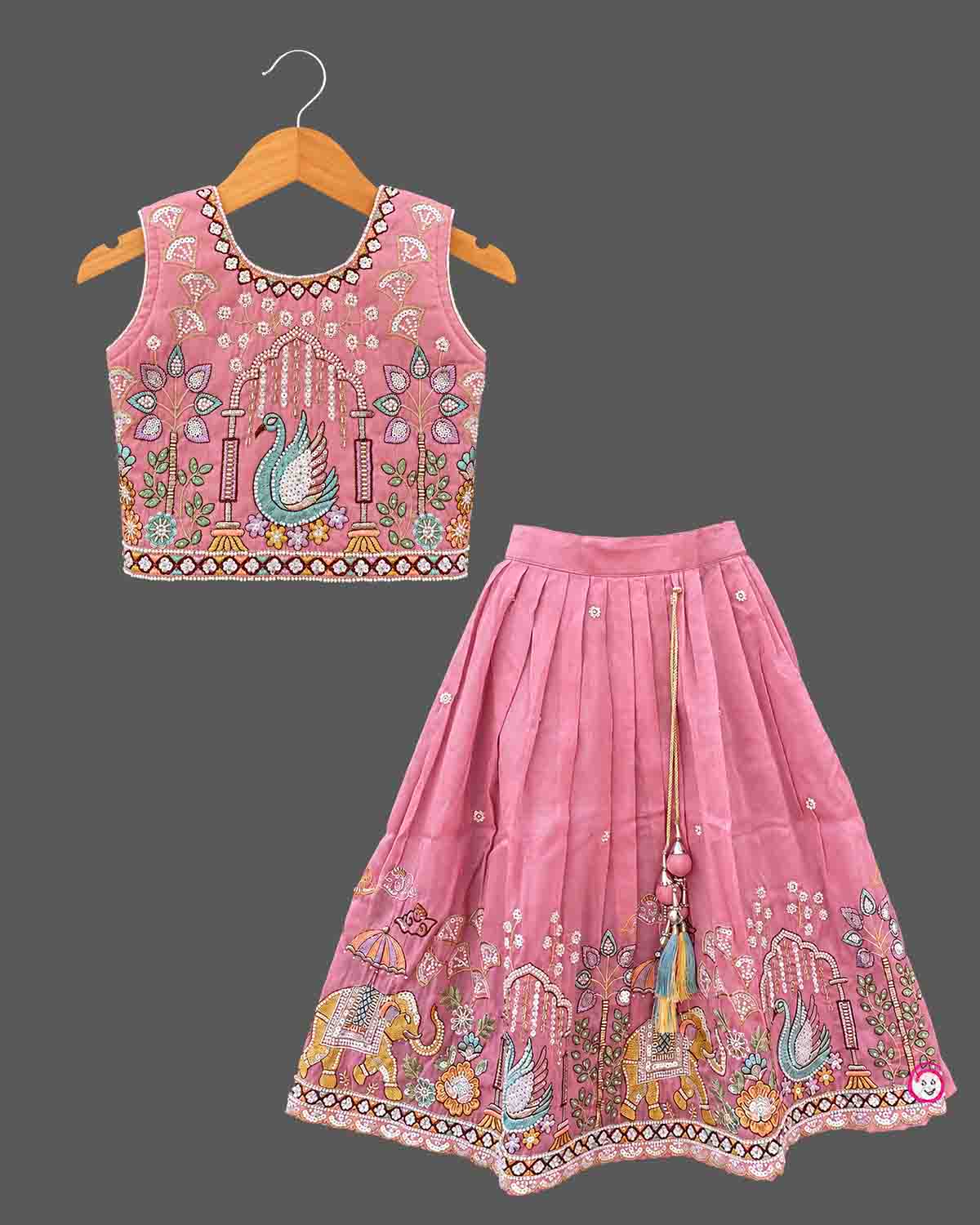 Designer baby girl lehenga set featuring hand-embroidered sequin motifs, sleeveless choli, and pleated flared skirt