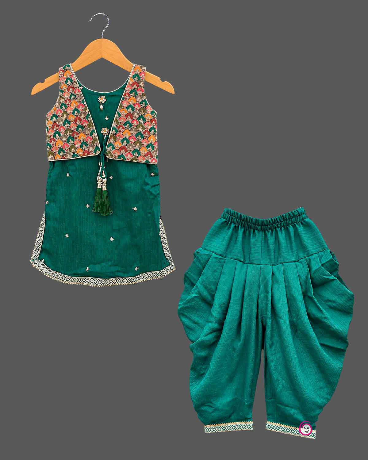Sleeveless short kurti with attached embroidered jacket and pleated dhoti patiyala pants for kids[cite: 5].
