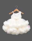 Embellished asymmetrical tulle silk frocks for baby girl featuring ruffled high-low hem.
