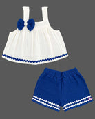 Sleeveless A-line top with decorative bow paired with wave-trimmed shorts.