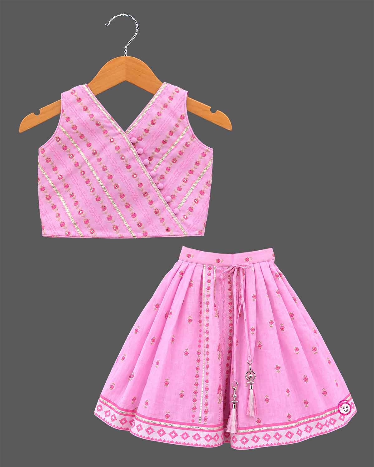 Girls angrakha lehenga choli set with floral prints, potli button details, and drawstring tassels.