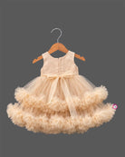 Beige cream net party frock for girls featuring sequin floral embroidery, sleeveless bodice, and tiered ruffle high-low hem design
