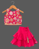 Girls floral embroidered sleeveless choli and tiered ruffle lehenga skirt set with drawstring tassel accents.