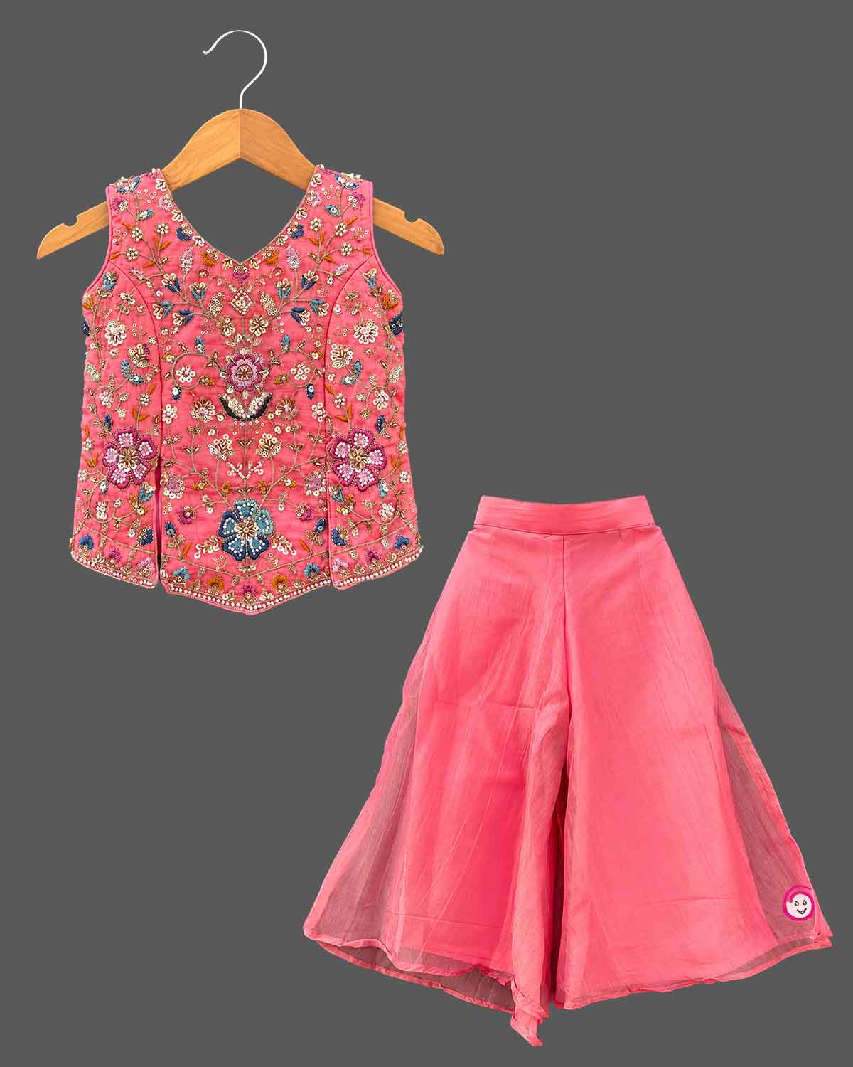 Kids sharara set featuring sleeveless hand-embroidered top, flared palazzo pants, and matching dupatta.