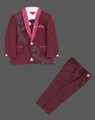 Maroon formal suit for little boys featuring a blazer with black and silver sequin details, a grey collar accent, white shirt, black tie, and matching maroon pant against a grey background.
