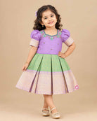 Pattu frock for girls with floral embroidered yoke, puff sleeves and zari border box-pleated skirt