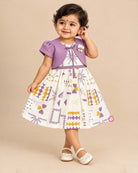 Little girl purple and off-white printed cotton casual frock with attached short sleeve jacket and floral brooch