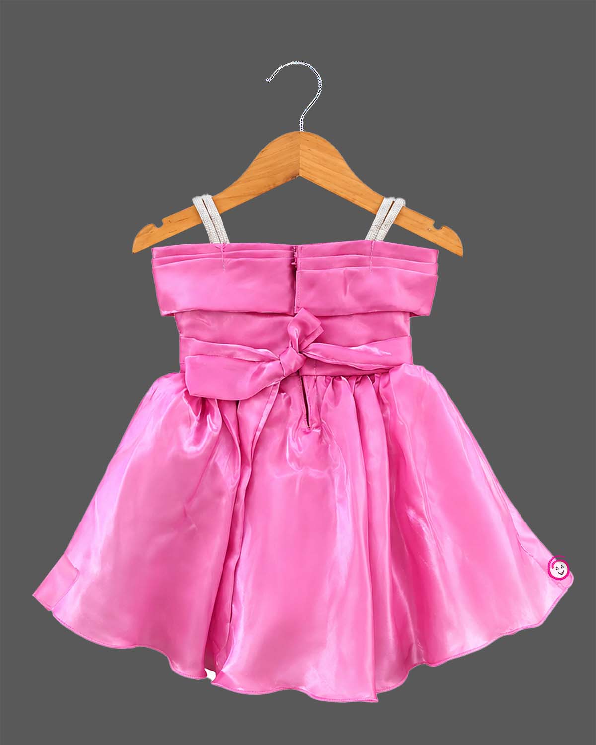 Pink satin and organza princess style party frock for baby girl featuring oversized side bow, rhinestone shoulder straps, and crystal brooch for first birthday outfit for girl and wedding celebrations