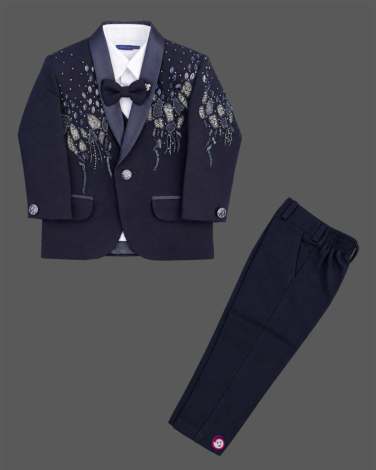 Boys formal tuxedo suit set featuring bead embellished blazer with bowtie and pant.
