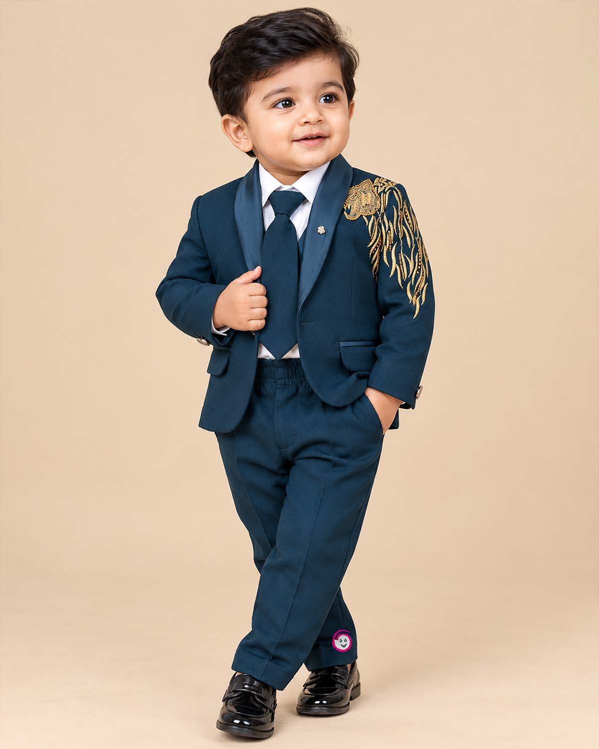 Boys embroidered tuxedo suit set featuring metallic shoulder embroidery, satin shawl lapel blazer, tie, and pant.