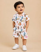 Boys 2-piece cotton casual co-ord set featuring a short-sleeve collared shirt and matching shorts in white with cactus, palm leaves, and desert botanical prints