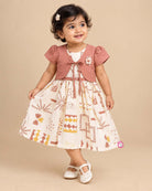 Little Girl Casual Frock featuring a cream dress with patterns and a peachish-pink textured shrug/jacket with a flower brooch and tie-up front.