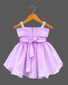 Lavender satin and organza party frock for baby girl featuring oversized side bow, rhinestone shoulder straps, and crystal brooch for birthday and wedding celebrations