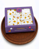 Printed newborn baby essential hamper featuring jhablas, nappies, bonnet, blanket, mittens, and booties perfect gifting combo