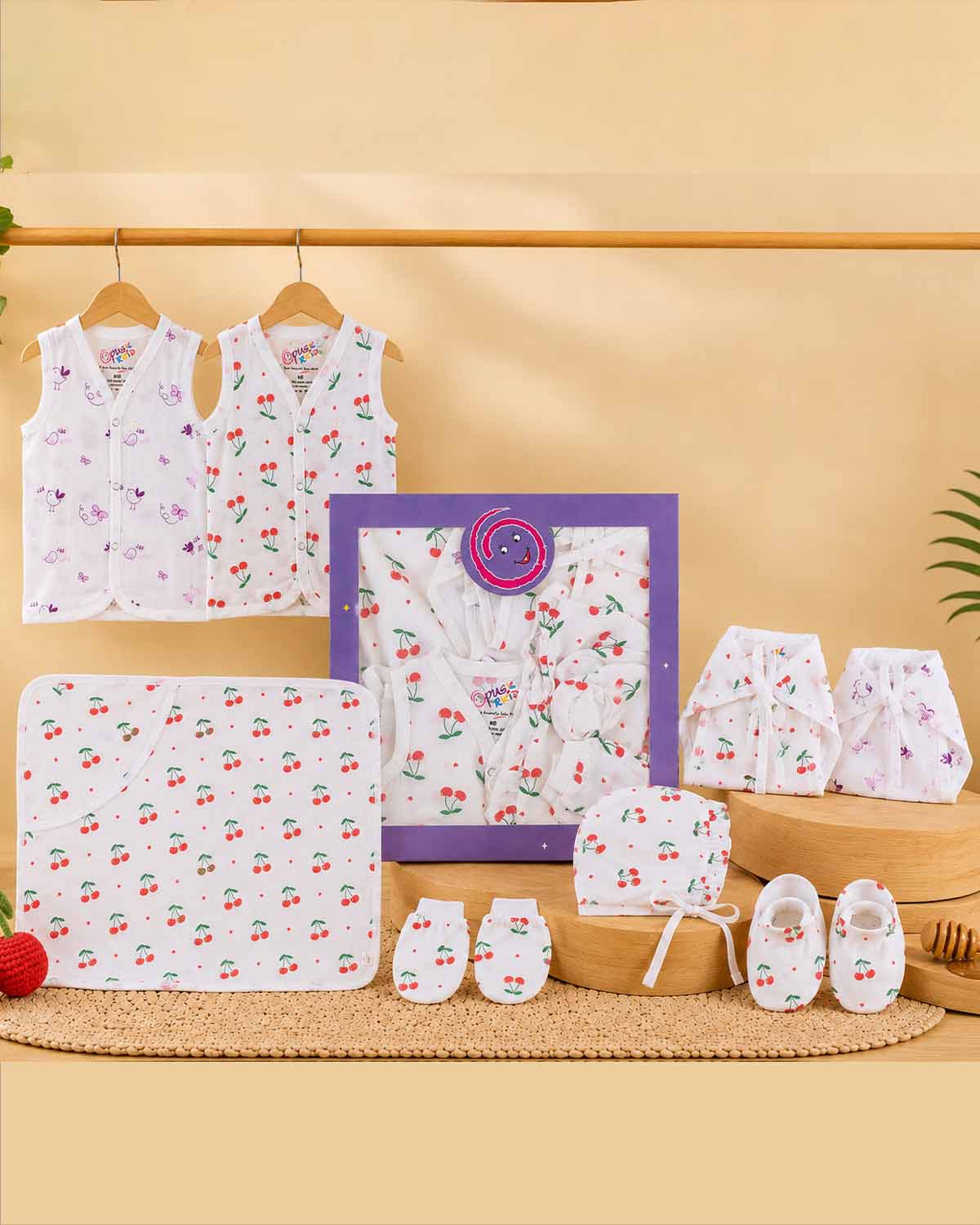 Complete infant layette gift hamper with sleeveless tops cloth nappies hooded swaddle sheet ruffled bonnet cap mittens and booties