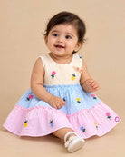Sleeveless striped tiered frock with floral embroidered motifs and decorative shoulder applique accents.