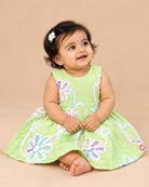 Sleeveless cotton A-line frock with floral lace appliqués and round neck for girls.