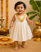 Traditional traditional baby frock for festivals with golden border details and bow accent