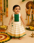 Girls traditional South Indian pattu pavadai choli set for Onam festival featuring gold zari borders