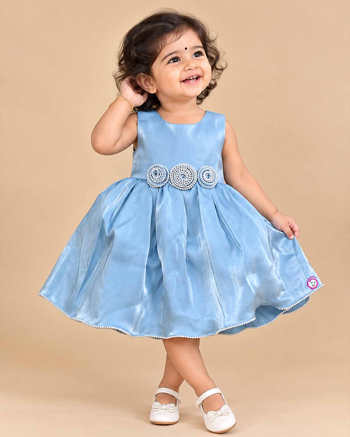 Powder blue satin frock for girls featuring floral beaded waist embellishments and pearl trim hem