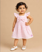 Sleeveless cotton casual frock with a checkered pattern and front bow detail hanging on a hanger.