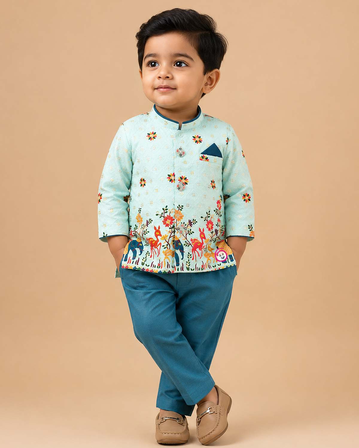 Boys light blue ethnic silk sherwani with vibrant elephant and deer motifs, mandarin collar, pocket square, paired with blue elastic waist pant
