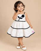 Baby Girl Tiered Frock with flower applique and zig-zag trim detailing for birthday Western wear .