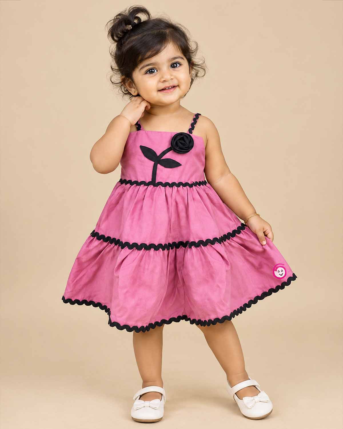 Toddler western frock with shoulder straps, scalloped wave trims, and a floral appliqué motif for celebrations and picnics.