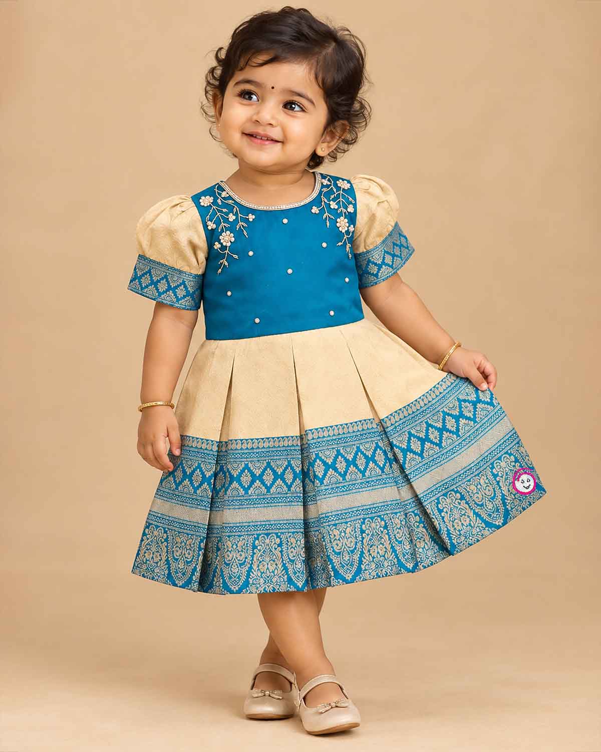 Kids silk ethnic frock featuring floral hand embroidery and woven zari border for traditional parties
