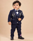 Boys formal tuxedo suit set featuring bead embellished blazer with bowtie and pant.