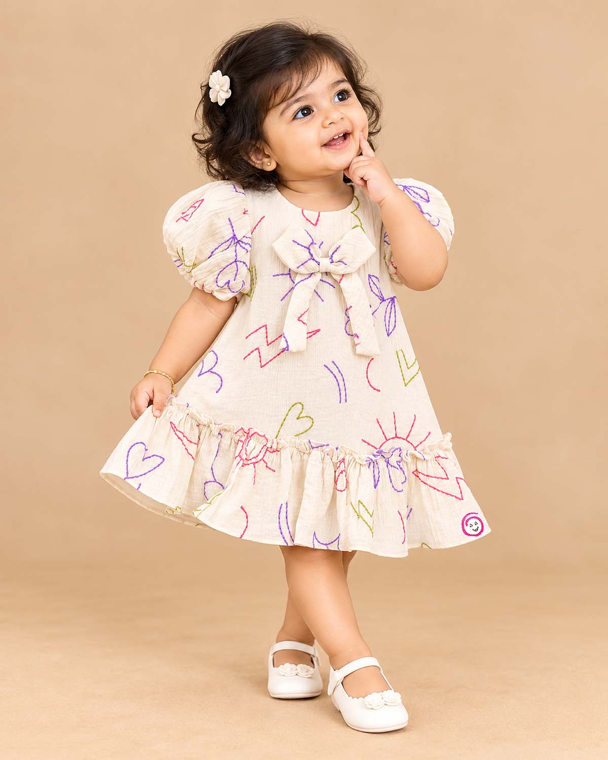 Girls casual printed frock with puff sleeves, front bow accent, and ruffled hem