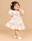 Girls casual printed frock with puff sleeves, front bow accent, and ruffled hem