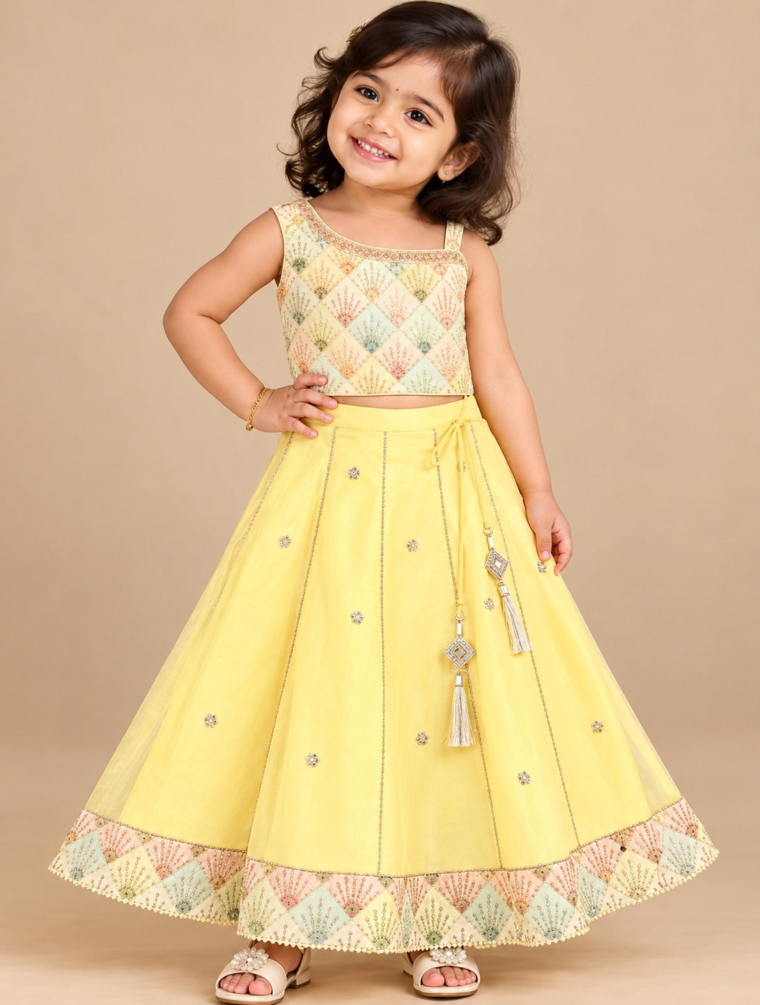 Girls sleeveless embroidered choli with square neck and flared ghagra skirt featuring tassel accents