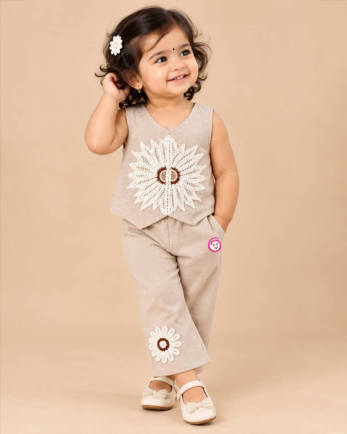 Kids party wear vest top and trouser set featuring crochet floral applique and back zipper closure.