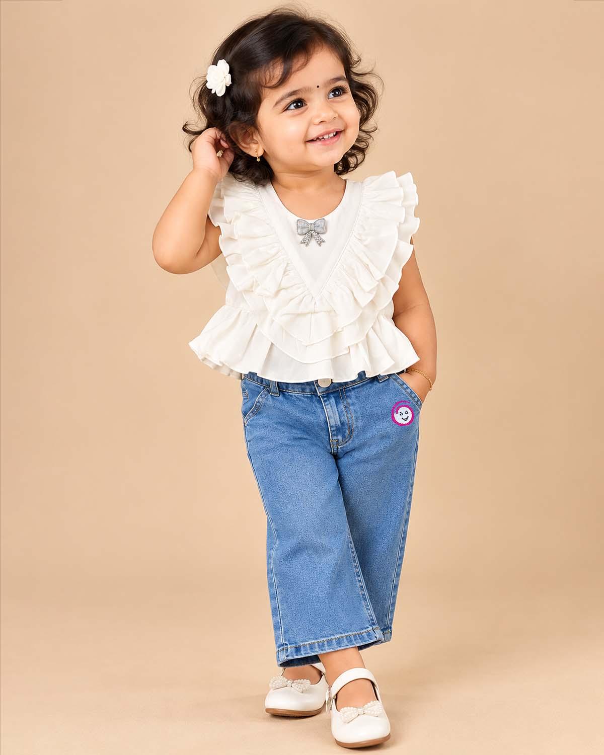 Ruffled top and denim pant baby party wear dress with embellished bow detail.